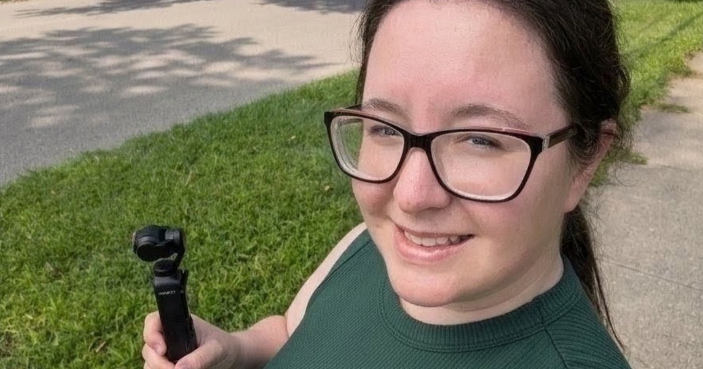 Judith holding a DJI Osmo Pocket 3 camera, filming for local businesses